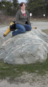 Jessica sitting on a rock near the Whitefish Point light house